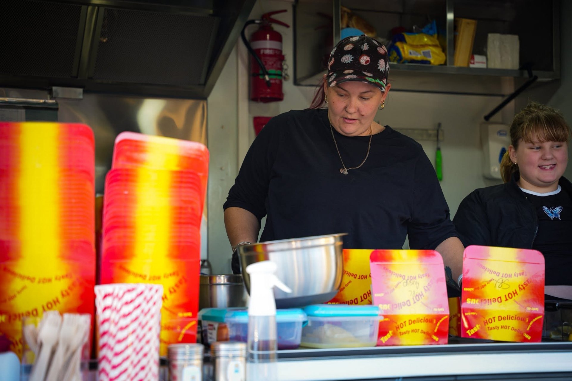 Mully & Lou's team cooking inside the food van at a school event