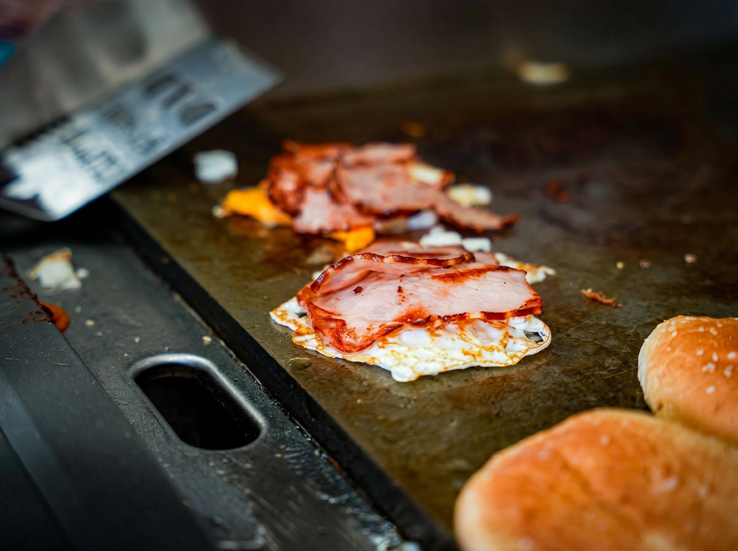Bacon and egg cooking on the grill
